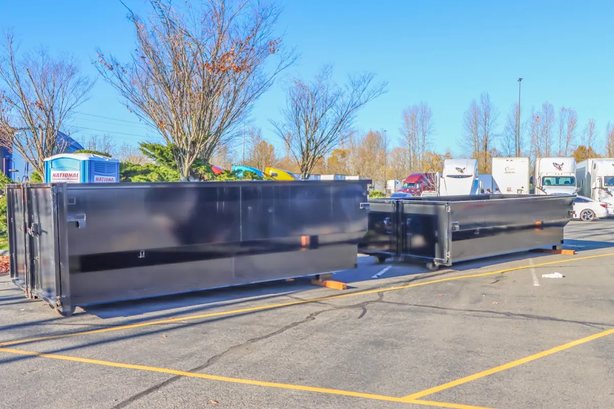 Professional dumpster rental service with roll-off container on residential driveway in Whitemarsh